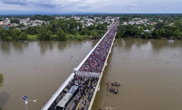 Migrants on the bridge at the Guatemala border yesterday.