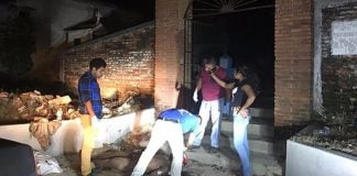 Coroner takes a call during sidewalk surgery.