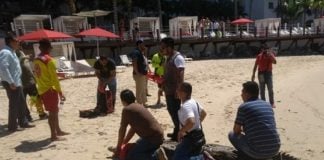 Crocodile is restrained on PV beach.