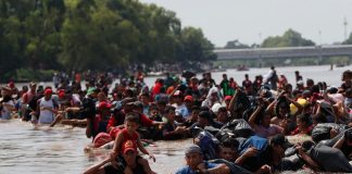 Migrants cross the river today between Guatemala and Mexico.