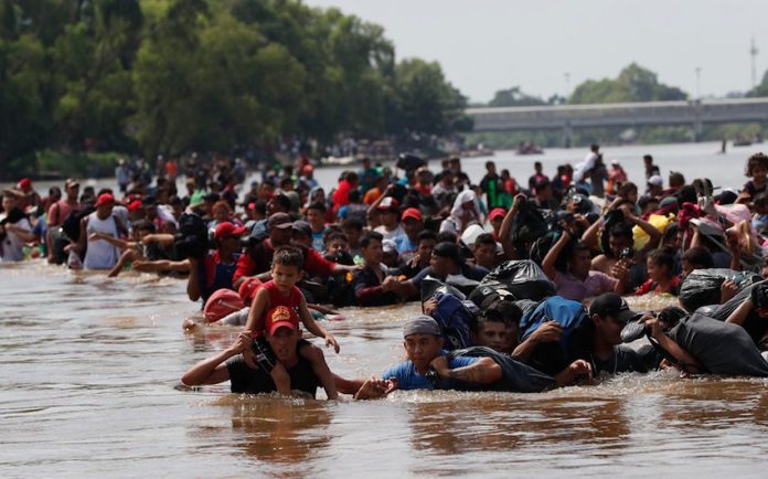 Migrants cross the river today between Guatemala and Mexico.