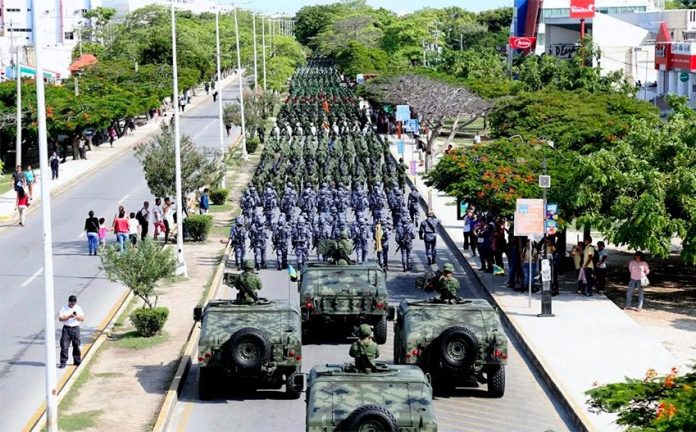 Military personnel march yesterday in Cancún to inaugurate new base.