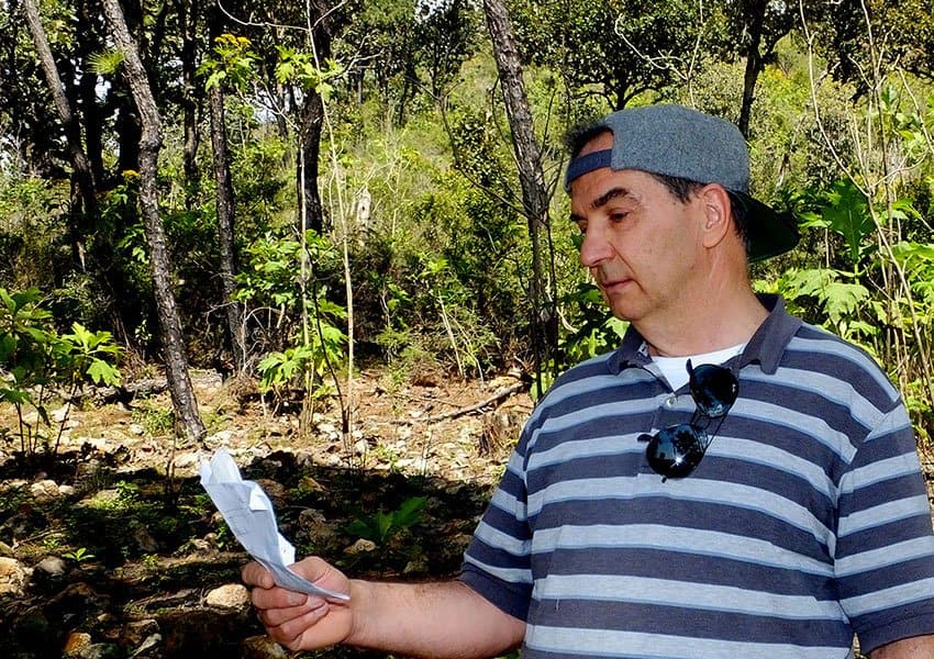 Vergara-Blanco checks map during visit to his study site.