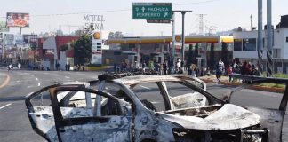 A burned-out car after Sunday's demonstration.