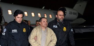 US agents escort Guzmán at his extradition last year.