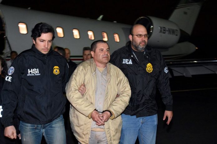 US agents escort Guzmán at his extradition last year.