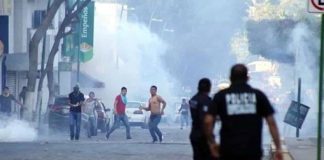 Protesters, police clash in Chiapas on Saturday.