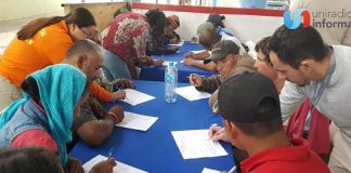 Central American migrants complete documents at Tijuana job fair.