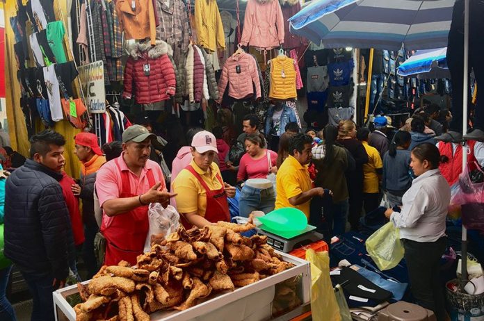 A chicharrones salesman works among thousands of vendors at the market in San Martín.