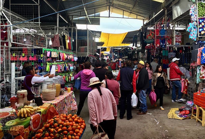 A seller of fruit-flavored water works in the center of the tianguistas, as the vendors are known.