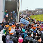 All aboard: migrants wait to climb into truck on their journey north.