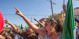 'Migrants out!' Tijuana protesters voice their disapproval over migrant arrivals.