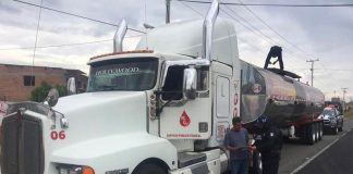 Tanker truck gets a police escort in Guanajuato.