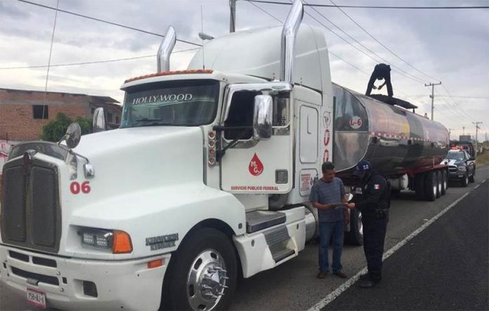 Tanker truck gets a police escort in Guanajuato.
