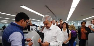 AMLO lines up at the gate to board his flight to Veracruz.