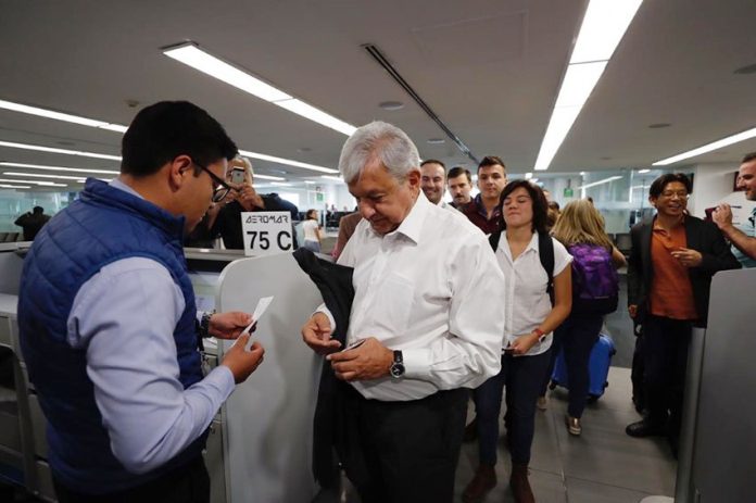 AMLO lines up at the gate to board his flight to Veracruz.