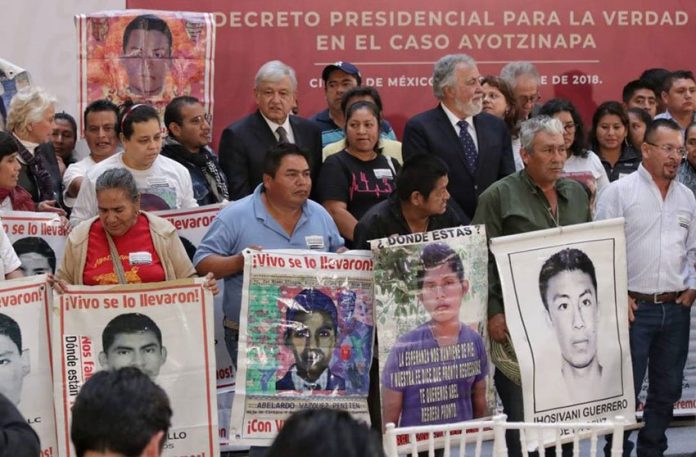 López Obrador with parents of the missing students during yesterday's signing of the decree.