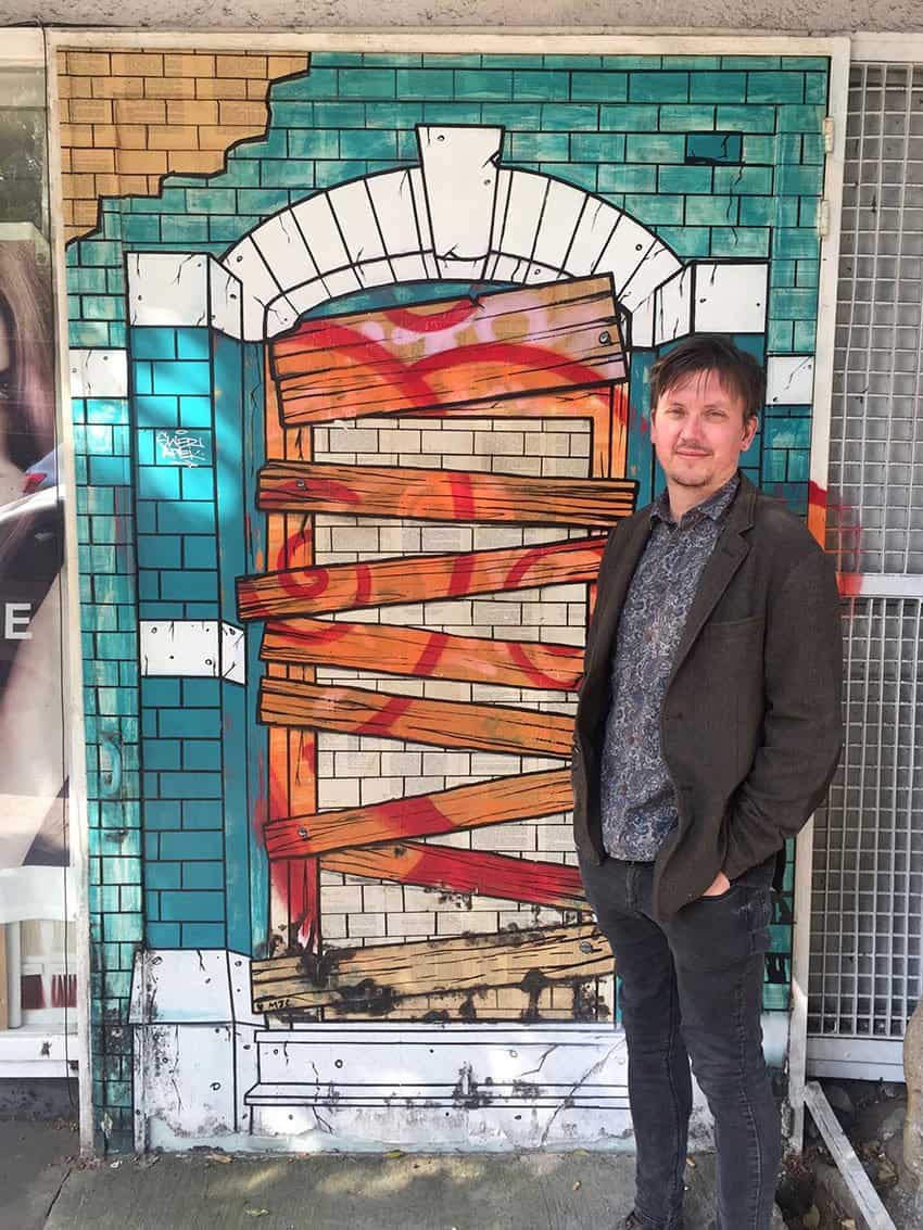 The artist in front of his mural in the Roma Norte neighborhood.