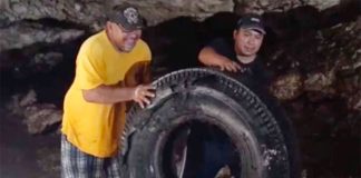 A tire is removed from a Yucatán cenote.