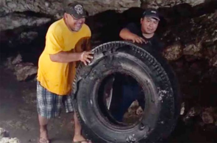 A tire is removed from a Yucatán cenote.
