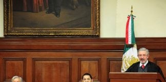 López Obrador and Morena party Deputy Martí Batres listen as Supreme Court justice Aguilar gives his address.