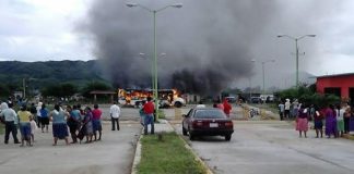 A bus burns during yesterday's election protest.