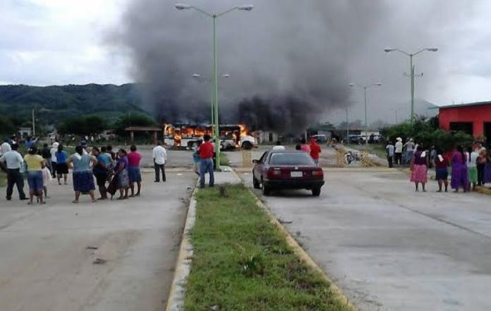 A bus burns during yesterday's election protest.