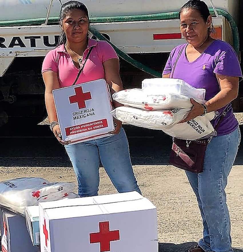 Red Cross workers with aid for victims.