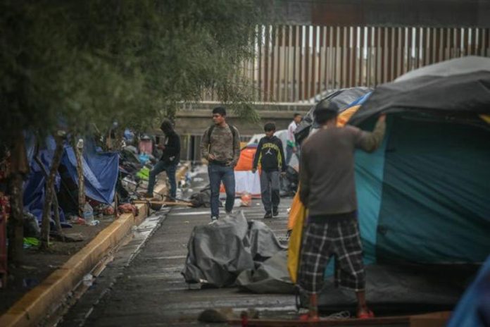 Migrants camping outside the Tijuana sports complex.