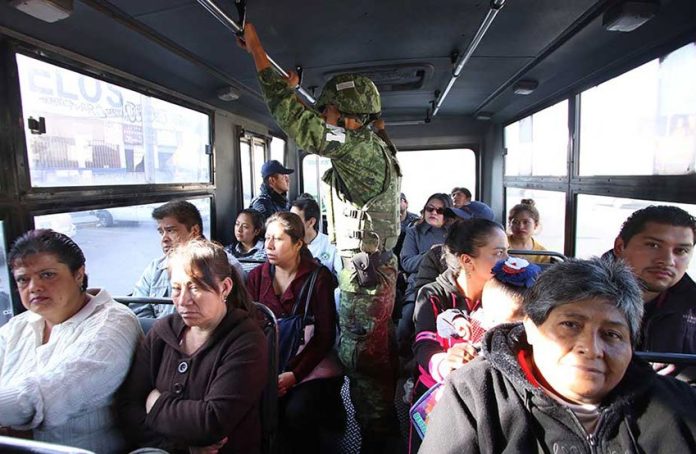 A member of the new National Guard on patrol on Puebla city public transit.