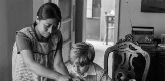 Yalitza Aparicio as Cleo with one of the children in her care.