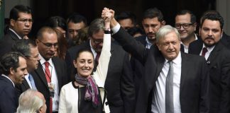 AMLO and Sheinbaum at the mayor's swearing-in ceremony.