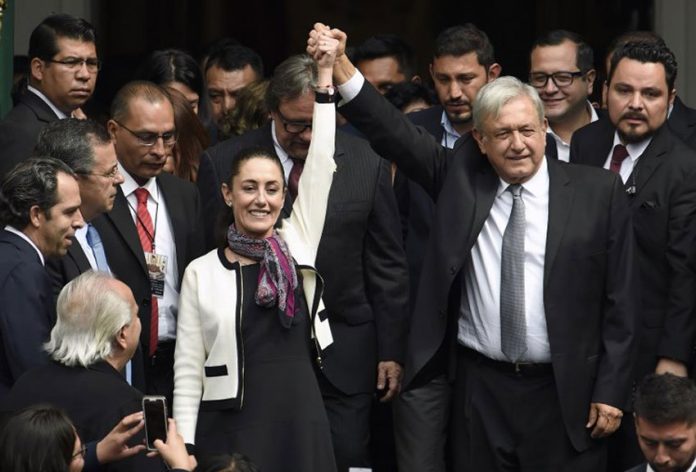 AMLO and Sheinbaum at the mayor's swearing-in ceremony.