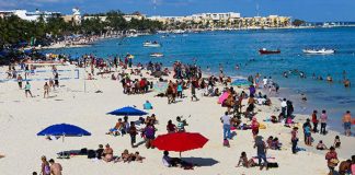 Tourists enjoy a Mexican beach.