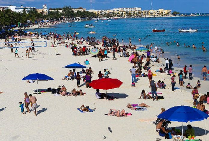 Tourists enjoy a Mexican beach.