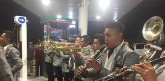 A brass band entertains motorists in Morelia early Wednesday morning.