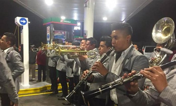 A brass band entertains motorists in Morelia early Wednesday morning.