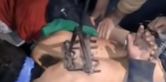 A suspected thief is branded on his back.