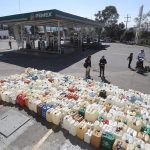 Hundreds of containers are lined up ready for the next shipment of gasoline to Morelia, Michoacán.
