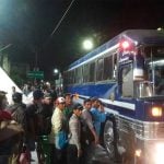 Migrants board a bus in Chiapas.