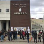 Workers protest against unpaid wages outside the Tijuana morgue in December.