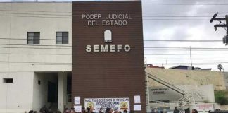 Workers protest against unpaid wages outside the Tijuana morgue in December.