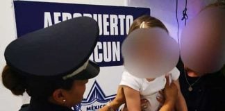 A police officer with the girl who had been taken from her mother.