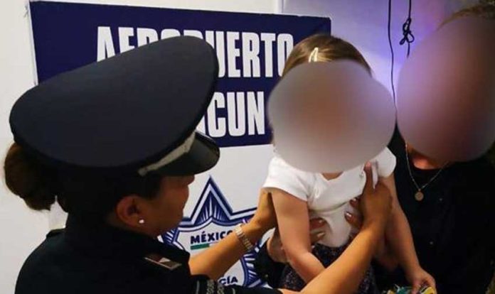 A police officer with the girl who had been taken from her mother.