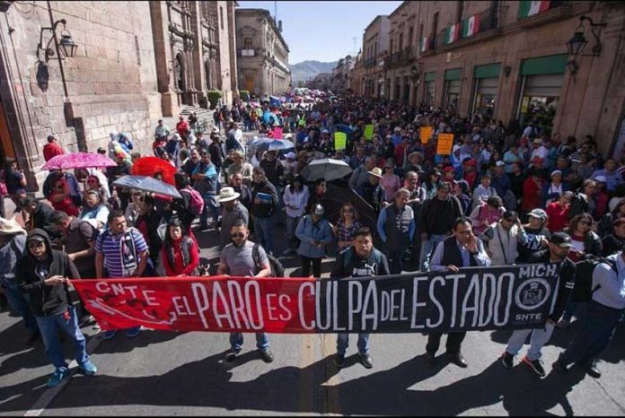 Striking teachers march in Oaxaca city.