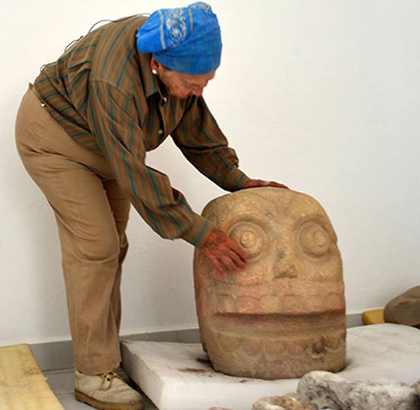 Archaeologist Castillo with one of the sculptures. 