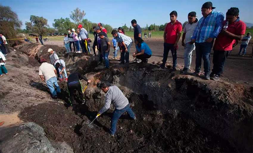 Searchers look for remains of the missing at the scene of the explosion.