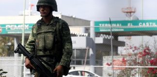 soldier stands guard at pemex