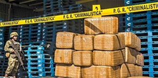 A soldier stands guard over cocaine seized off the coast of Guerrero.