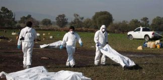Victims' remains are removed from the scene of the Hidalgo explosion and fire.